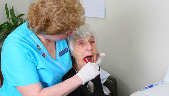 dentist brushing patient's teeth